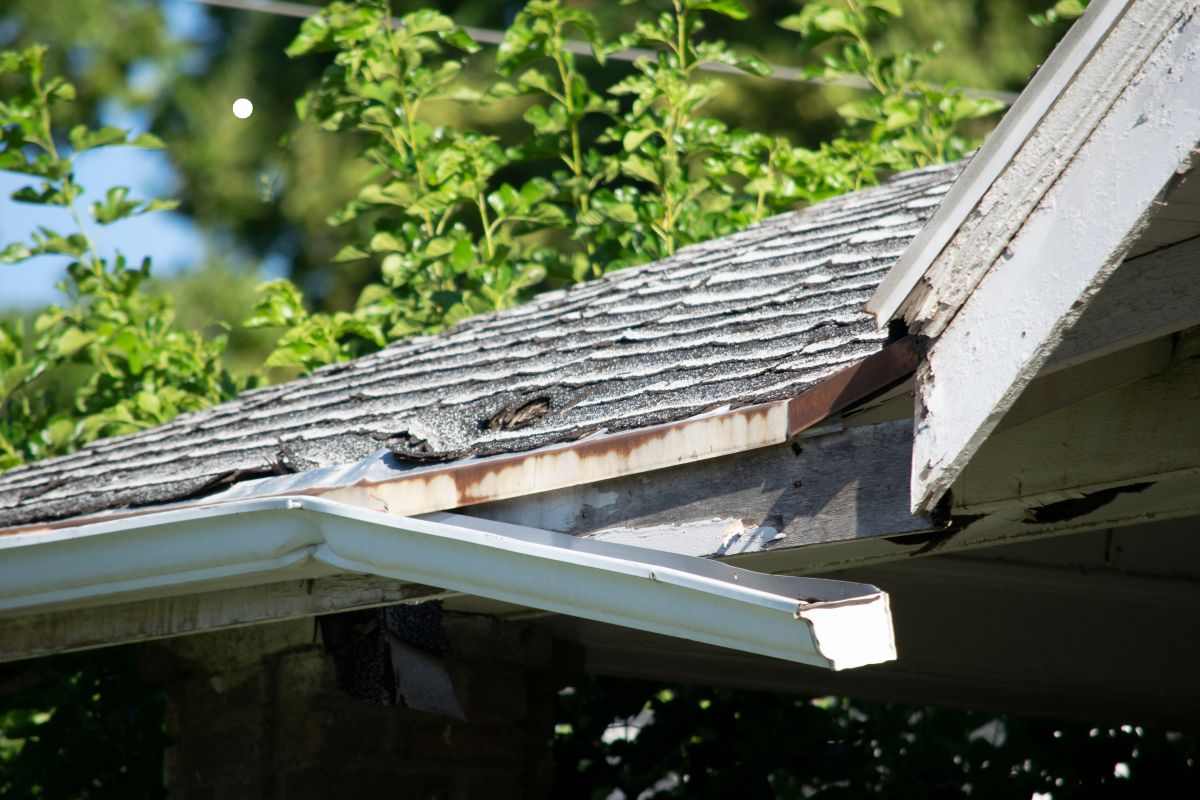 Close-up view of a metal roof gutter, showcasing its design and functionality for effective water drainage.